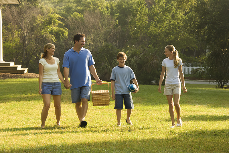 Family walking in park.