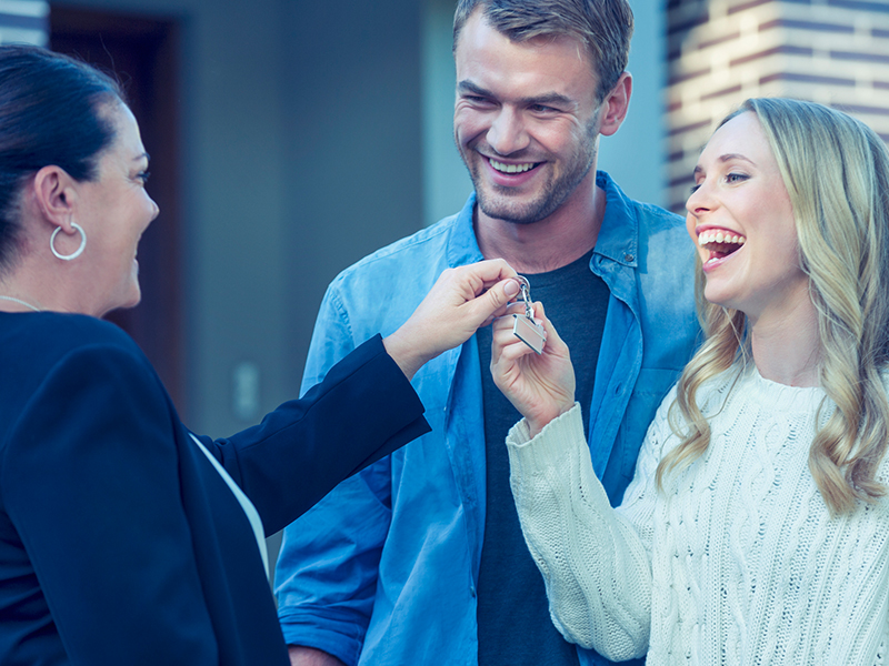Youngsville, NC Realtor Handing Home Key to Happy Couple